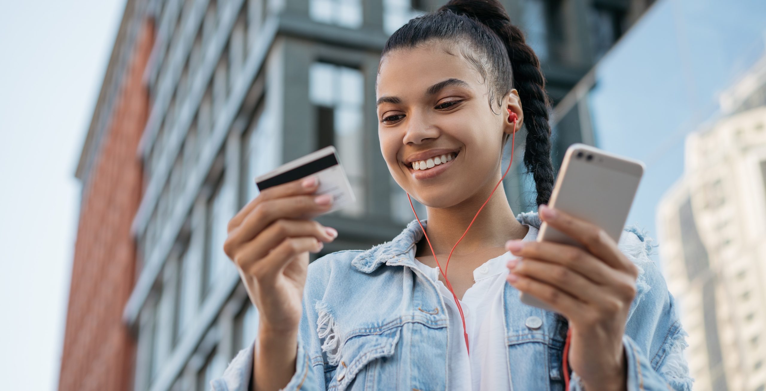 African,American,Woman,Holding,Credit,Card,,Using,Smartphone,For,Online